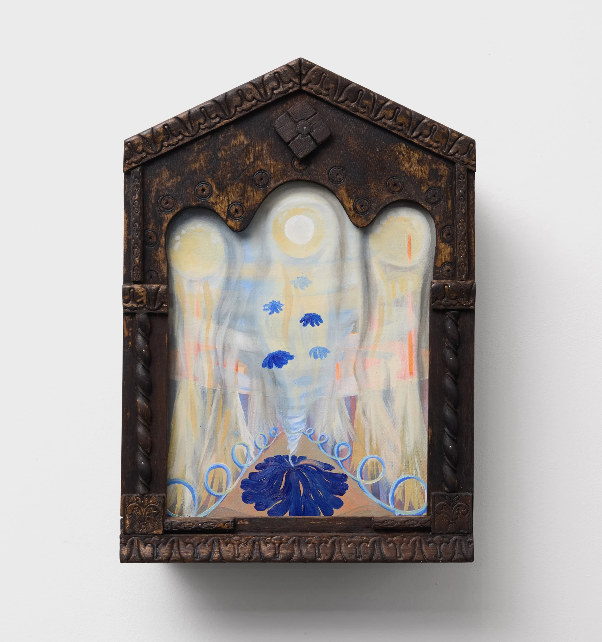 An oil painting with abstract and floral forms framed in an antique wooden kiot.